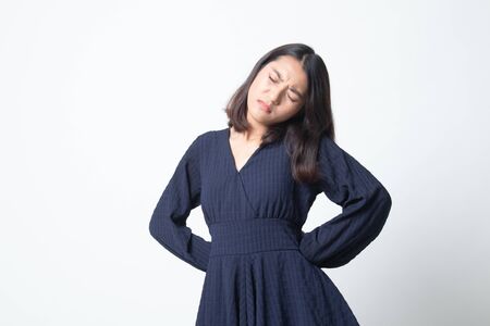 Young Asian woman got back pain on white backgroundの写真素材
