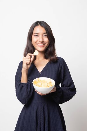 Young Asian woman eat potato chips on white backgroundの写真素材