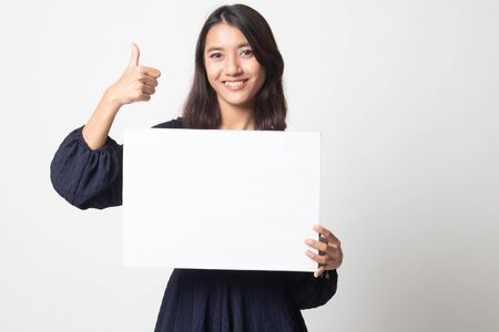 Young Asian woman show thumbs up with  white blank sign on white backgroundの写真素材