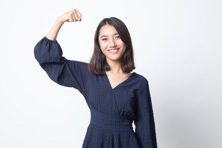 Beautiful young Asian woman flex bicep on white backgroundの写真素材