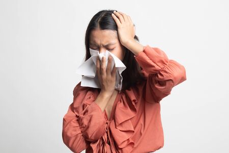 Young Asian woman got sick and flu on white backgroundの写真素材