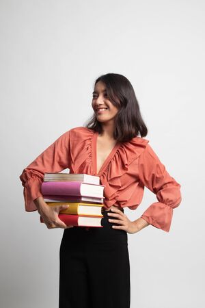 Young Asian woman studying  with may books on white backgroundの写真素材