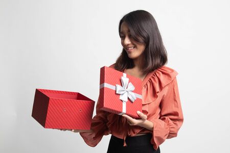 Young Asian woman open a gift box on white backgroundの写真素材