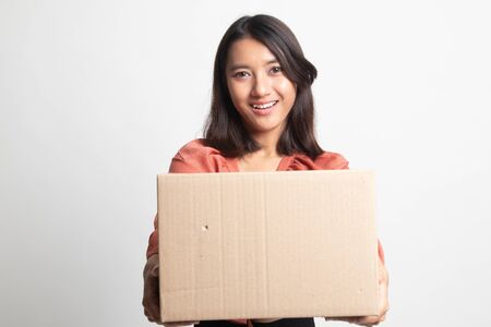 Delivery, relocation and unpacking.  young asian woman holding cardboard box on white backgroundの写真素材
