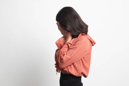 Sad young Asian  woman cry with palm to face on white backgroundの写真素材