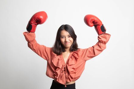 Young Asian woman with red boxing gloves on white background
