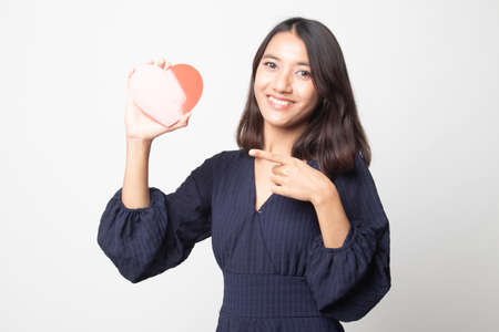 Asian woman thumbs down with red heart on white backgroundの写真素材