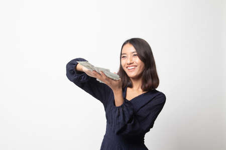 Portrait of very happy  young asian woman throwing out money banknotes on white backgroundの写真素材