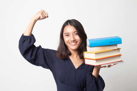 Young Asian woman studying  with may books on white backgroundの写真素材