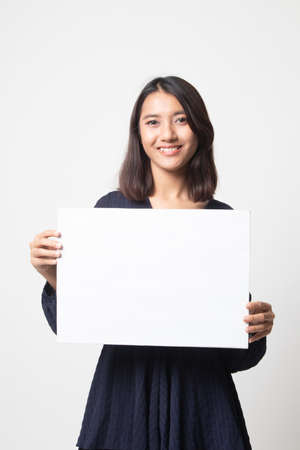 Young Asian woman with white blank sign on white backgroundの写真素材