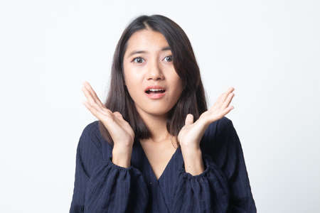 Shocked young Asian woman on white backgroundの写真素材