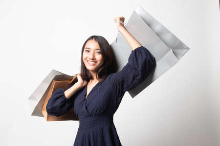 Young Asian woman happy with shopping bag on white background