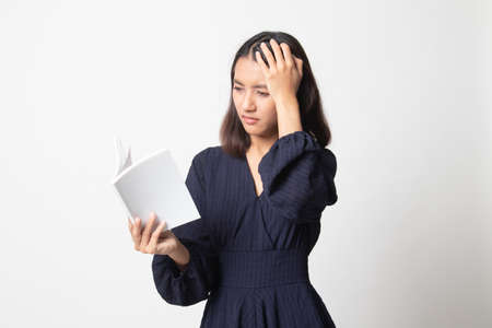 Young Asian woman got headache read a book on white backgroundの写真素材