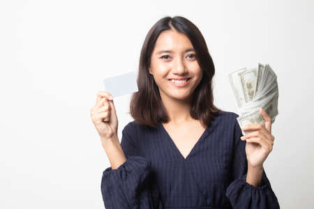 Portrait of  young asian woman  showing bunch of money banknotes on white backgroundの写真素材