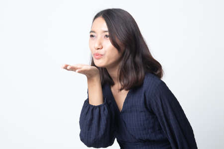 Beautiful young Asian woman blow a kiss on white backgroundの写真素材