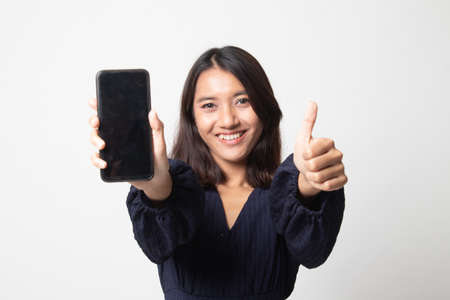 Young Asian woman show thumb up  with mobile phone on white backgroundの写真素材