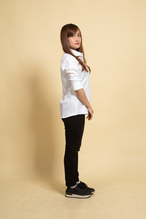 Side Full body of beautiful young asian woman on beige backgroundの写真素材