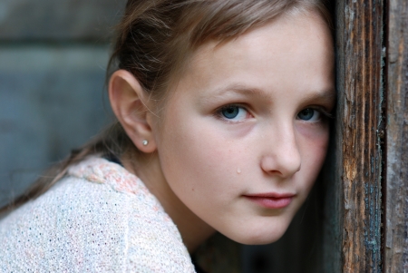 Sad little girl feels lonely の写真素材