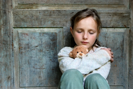 Sad little girl feels lonely の写真素材