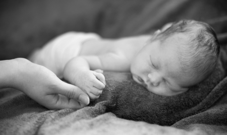 Little newborn girl is sleeping.
