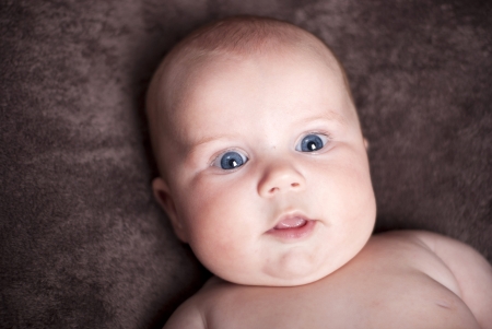 Three months old baby has lot of fun.の写真素材
