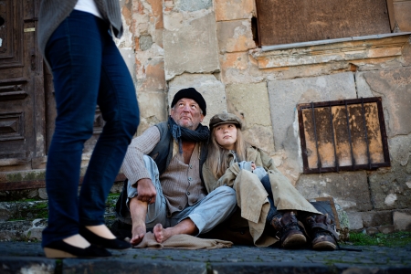 Abandoned people on the street are asking for moneyの写真素材