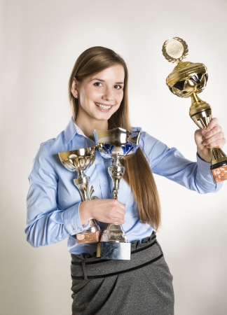 Portrait of successful business woman with trophy.の写真素材