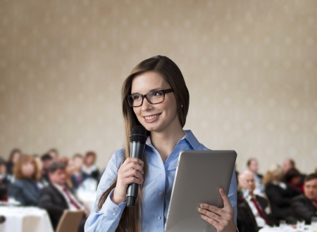 Beautiful business woman is speaking on conference.の写真素材