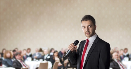 Man is speaking on indoor business conference for managers の写真素材