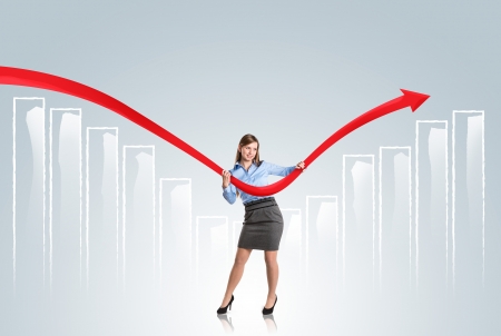 Business woman is trying to increase market statistics.の写真素材