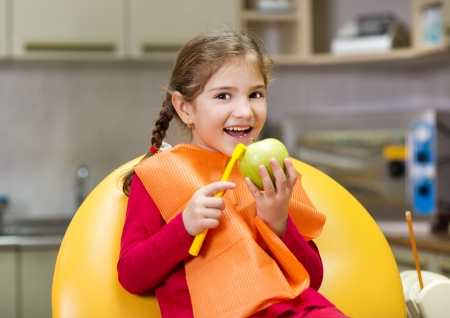 Dentist is showing the technique of teeth cleaning to a little girlの写真素材