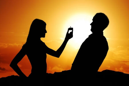 Funny proposal scene with happy woman and man の写真素材