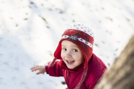 Little girl is playing outside in cold winter の写真素材