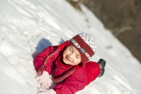 Little girl is playing outside in cold winter の写真素材