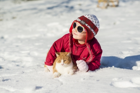 Little girl is playing outside in cold winter の写真素材