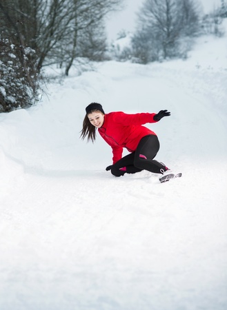 Athlete woman is running during winter training outside in cold snow weather の写真素材