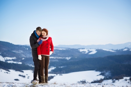 A young man is asking to married a beautiful girl in snow country の写真素材