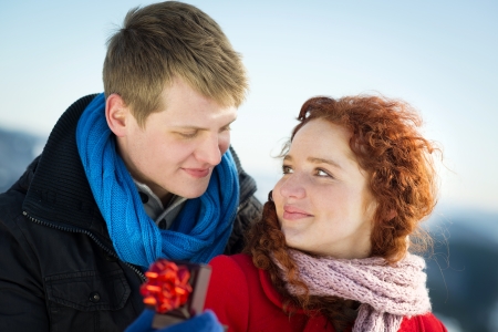 A young man is asking to married a beautiful girl in snow country の写真素材