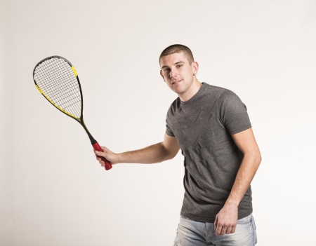 Squash player with racquet isolated on white backgroundの写真素材