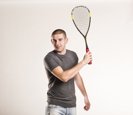 Squash player with racquet isolated on white backgroundの写真素材
