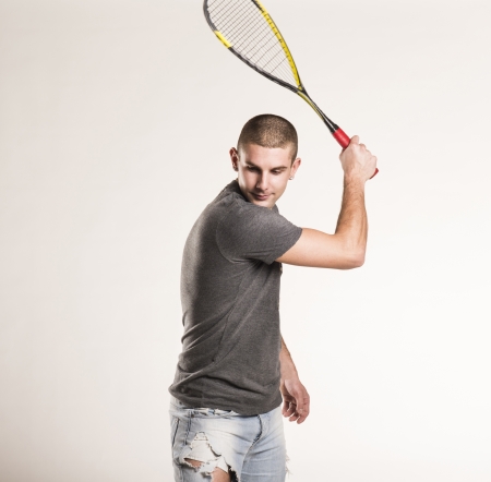 Squash player with racquet isolated on white backgroundの写真素材