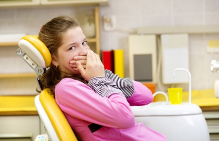 Little girl is being scared at the dentistの写真素材