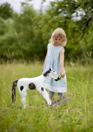 Happy family is playing together in a green meadow.の写真素材