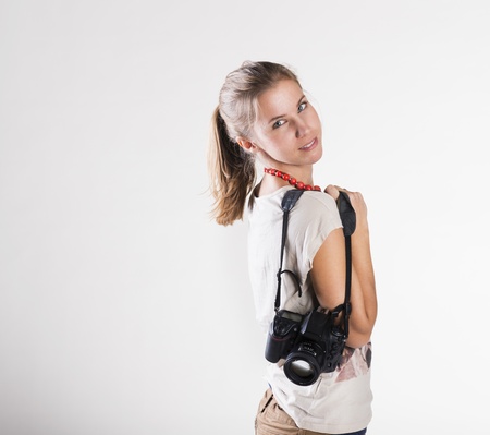 Young photographer with camera isolated on white backgroundの写真素材