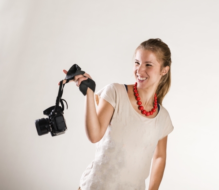 Young photographer with camera isolated on white backgroundの写真素材