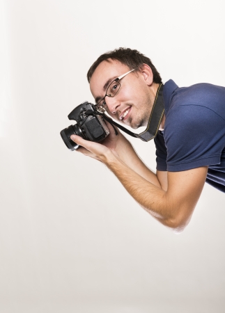 Young photographer with camera isolated on white backgroundの写真素材