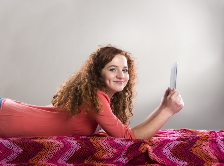 Beautiful girl with tablet is isolated on white backgroundの写真素材