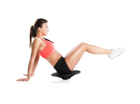 Young beautiful model with fitness balance boardの写真素材