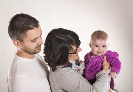 Beautiful family is posing in studio with white backgroundの写真素材