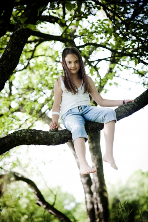 Cute little girl is playing outside in the countryの写真素材